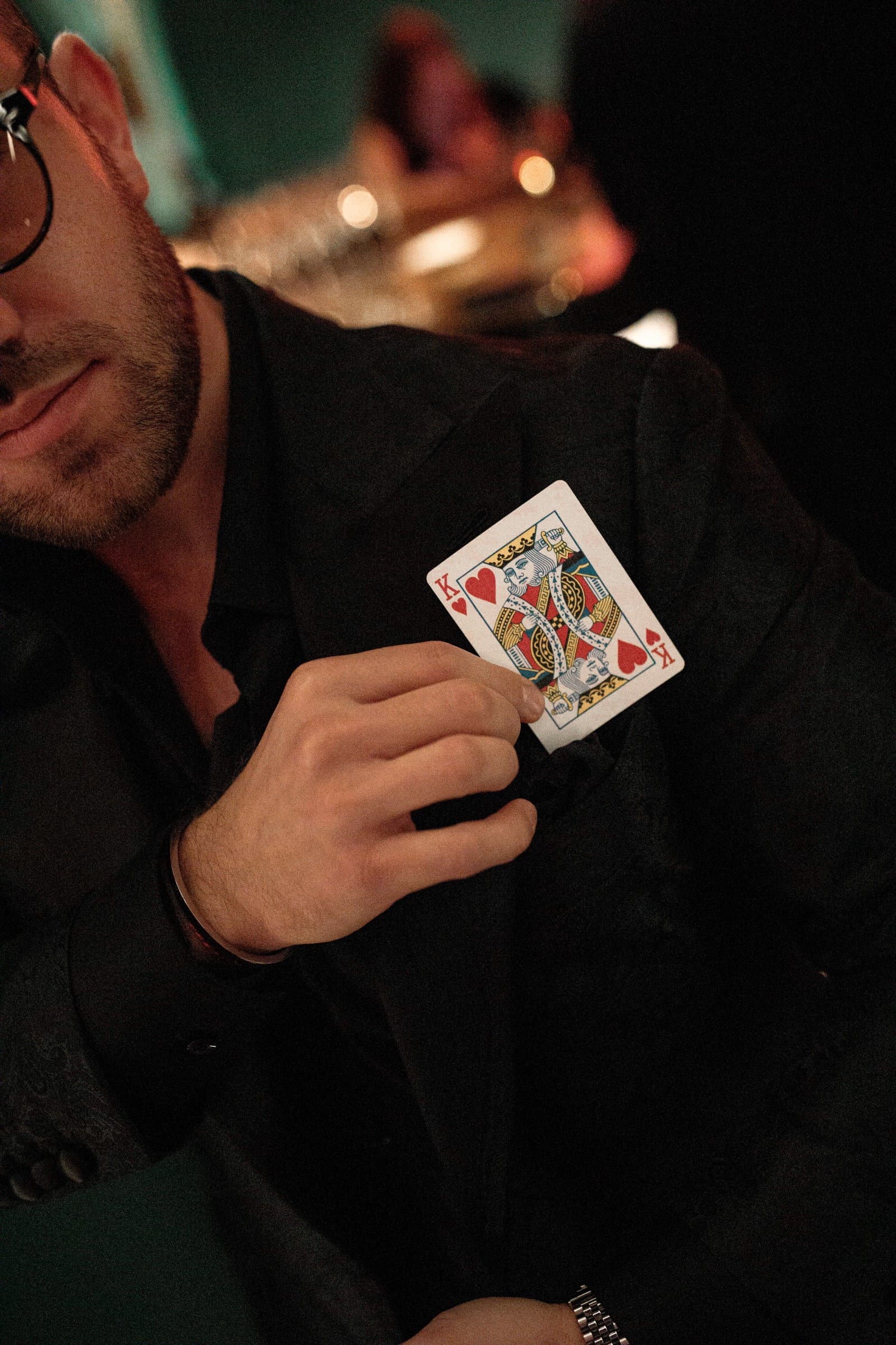 The king of hearts drawn slowly from a breast pocket.